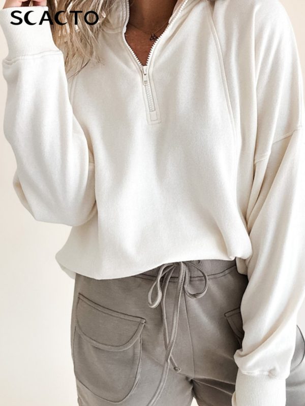 new white half zip casual top women's loose style, showing relaxed style, fashionable piece for spring and autumn seasons